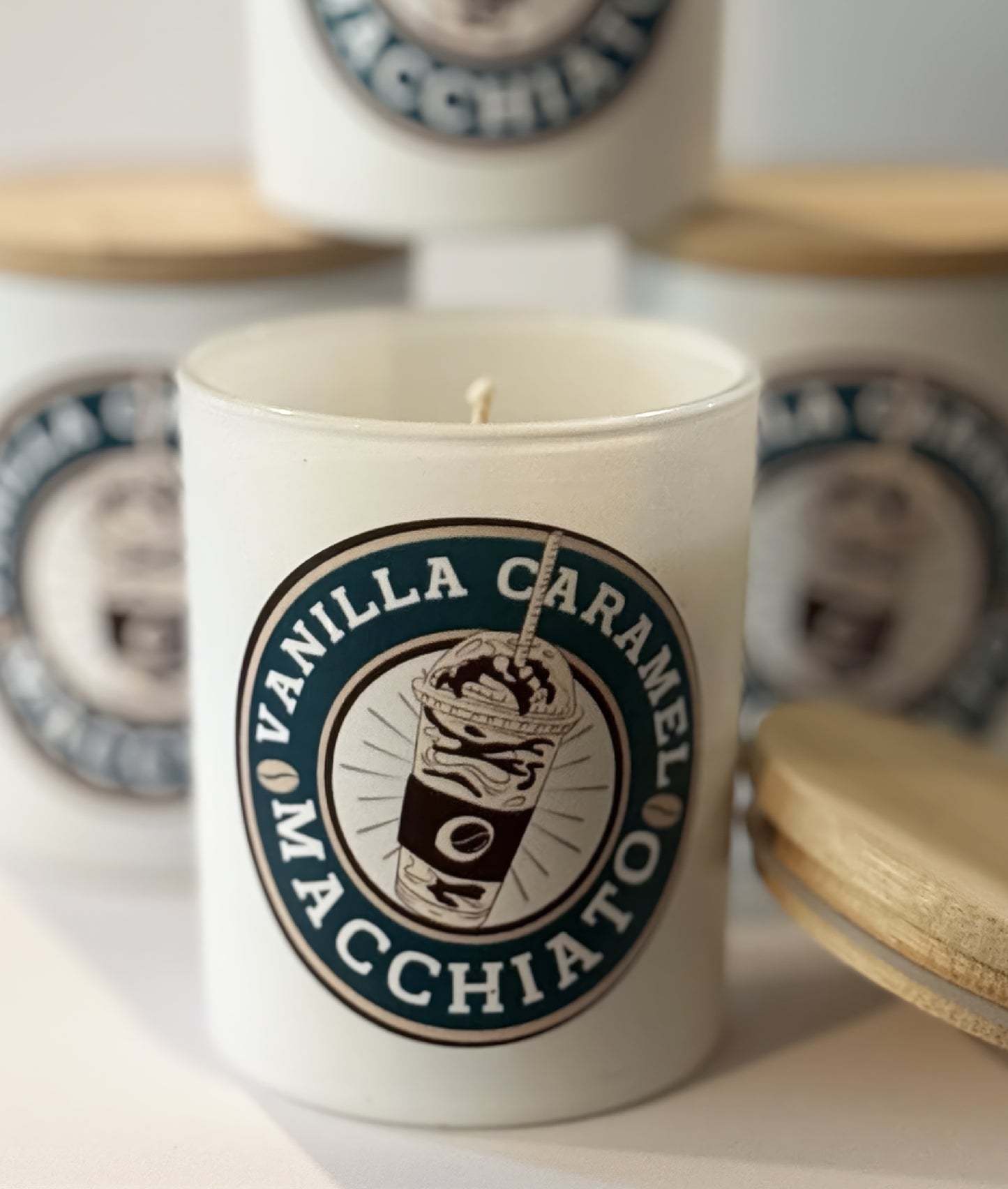 Candle with 'Vanilla Caramel Macchiato' label on a white surface