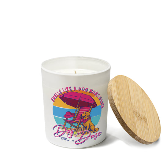 Candle with a colorful design featuring a dog and beach chair, labeled 'Dog Daze', on a white background.