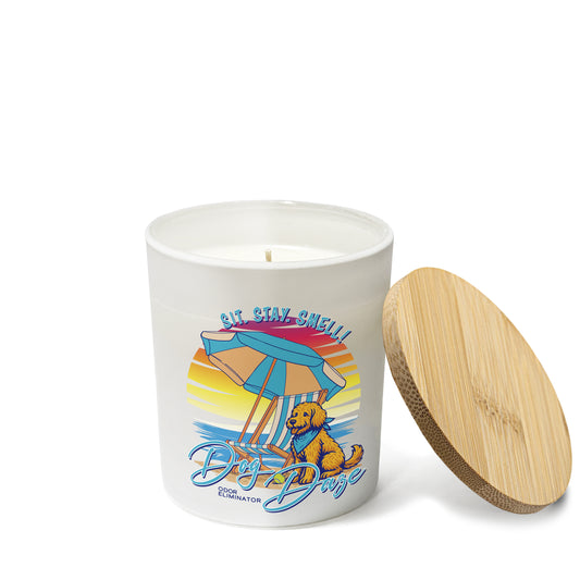 Candle with a beach-themed design featuring a dog and umbrella, on a white background.